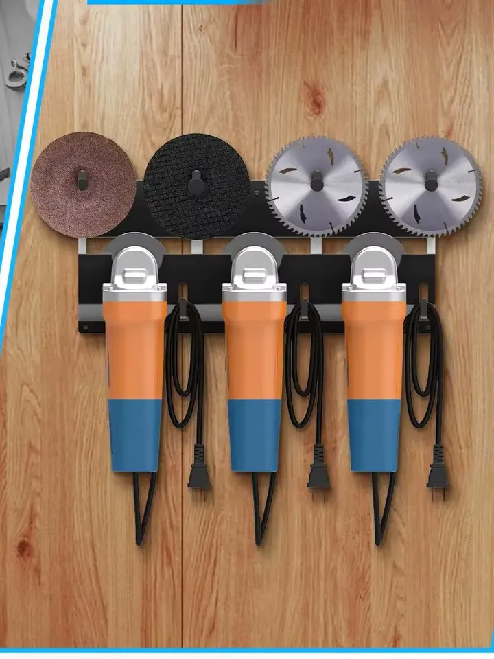 Three angle grinders hung side by side on a black steel wall mount