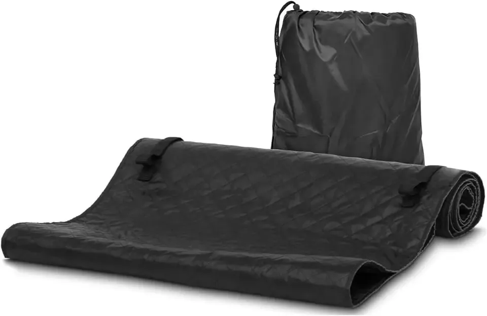 A padded black creeper mat rolled up beside its drawstring storage bag