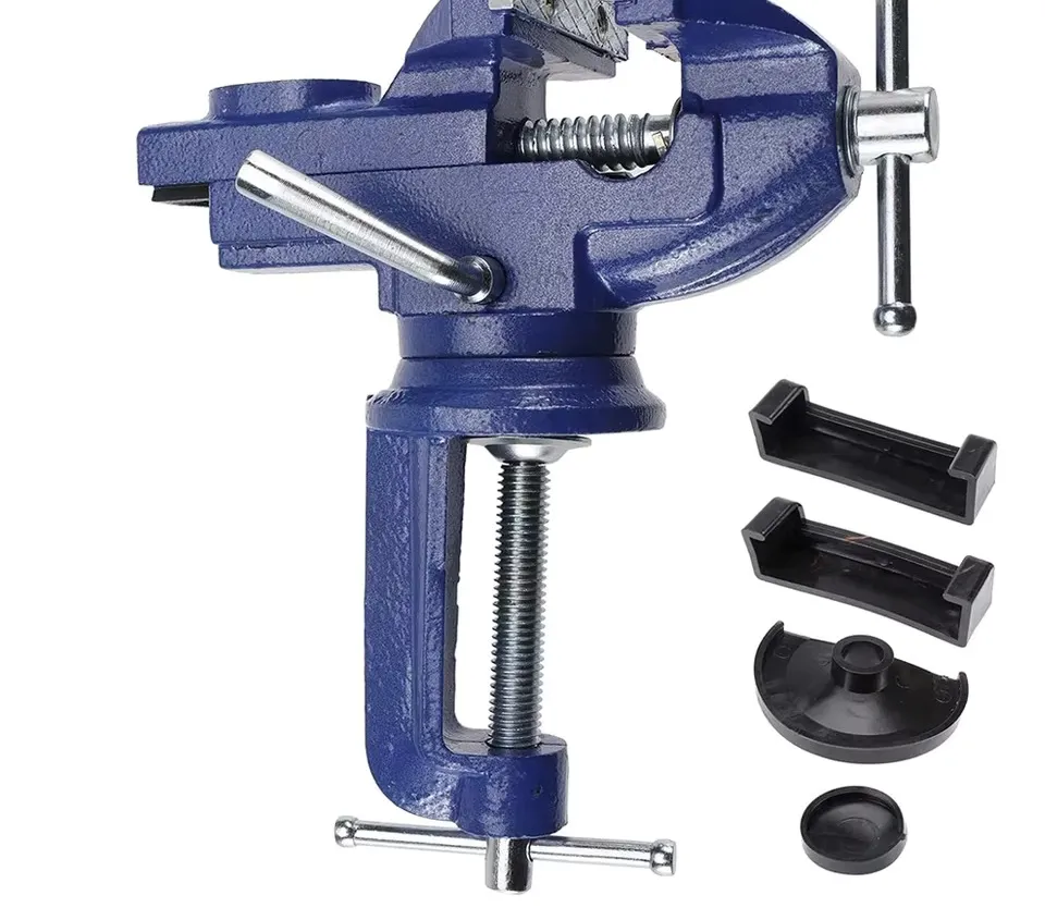 A blue cast-iron clamp-on bench vice with its swivel base and spare jaws